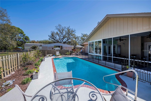 view of swimming pool featuring ceiling fan and a patio area