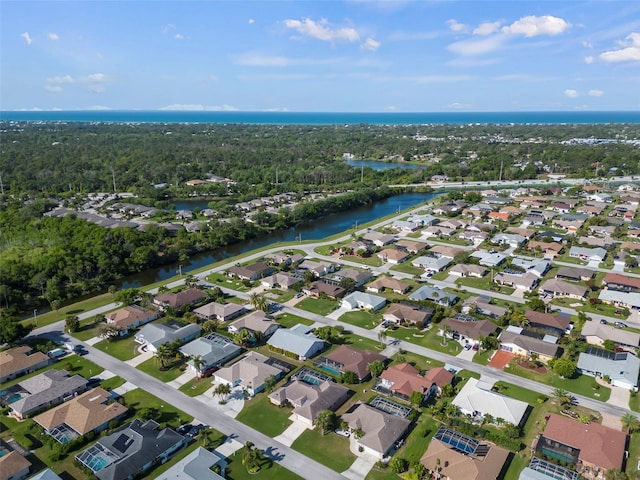 bird's eye view with a residential view, a water view, and a view of trees