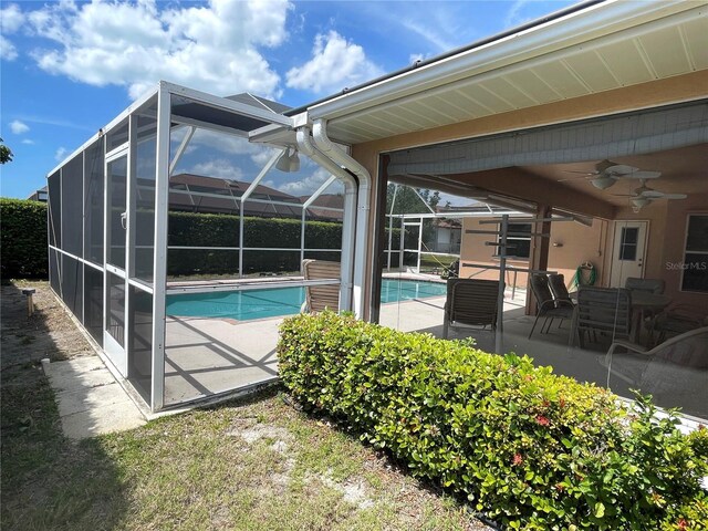 pool featuring a lanai, a ceiling fan, and a patio