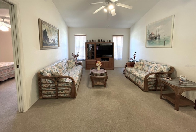 carpeted living room featuring ceiling fan and lofted ceiling