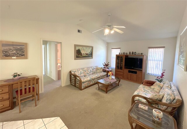 living room with ceiling fan, light colored carpet, and lofted ceiling