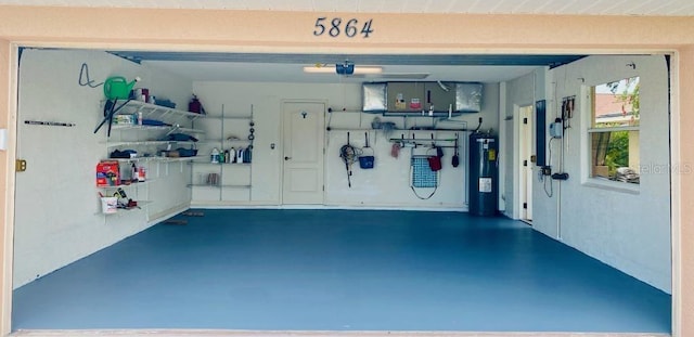 garage with a garage door opener and water heater