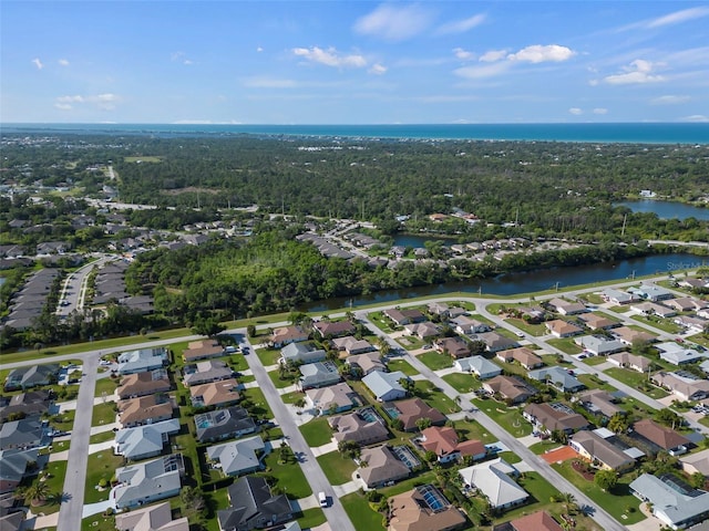 drone / aerial view with a residential view and a water view