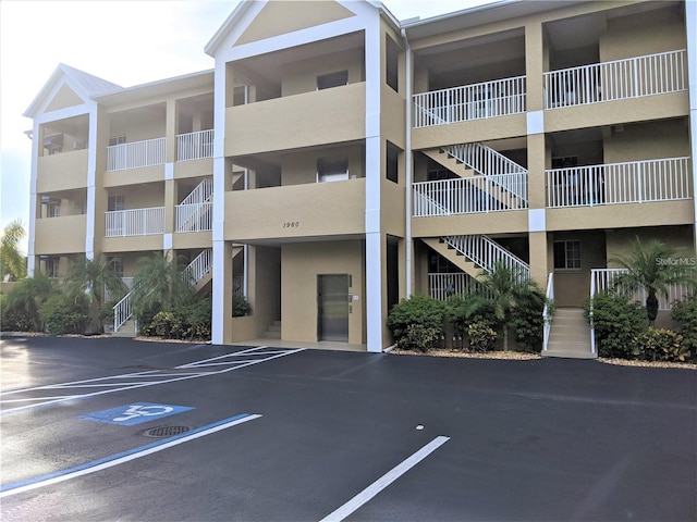 view of building exterior featuring uncovered parking