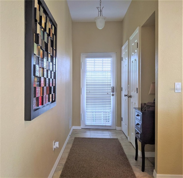 doorway with light tile patterned flooring