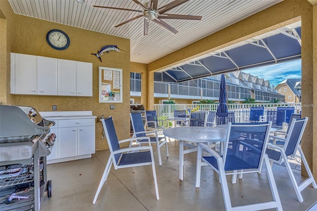 view of patio with ceiling fan and a grill