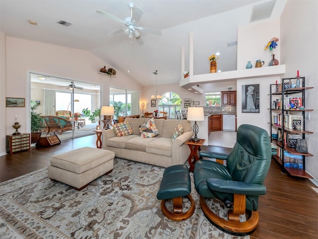 living room with lofted ceiling, ceiling fan, and hardwood / wood-style flooring