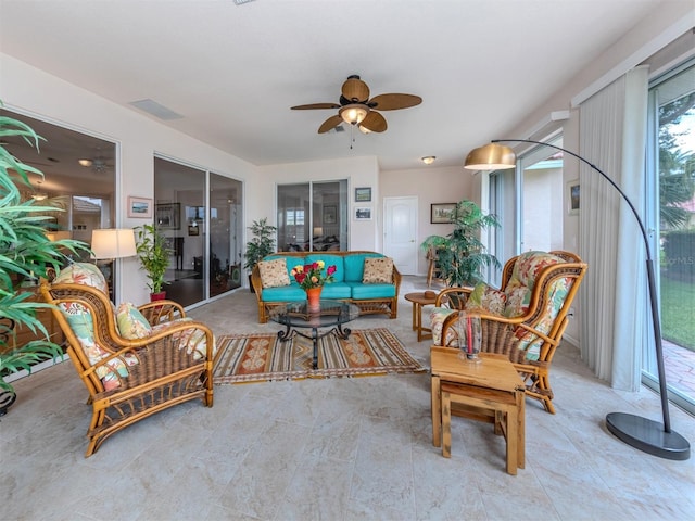 interior space with ceiling fan