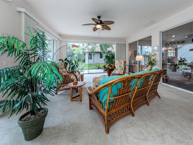 living room featuring a healthy amount of sunlight and ceiling fan