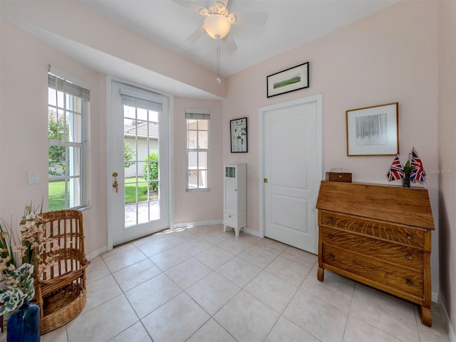 interior space featuring light tile patterned floors and ceiling fan