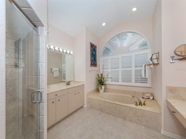 bathroom featuring plus walk in shower, vaulted ceiling, tile patterned flooring, and vanity