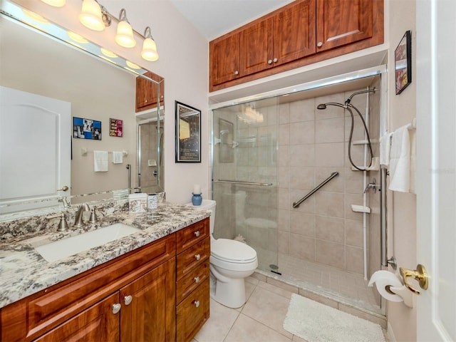 bathroom with tile patterned flooring, vanity, toilet, and walk in shower