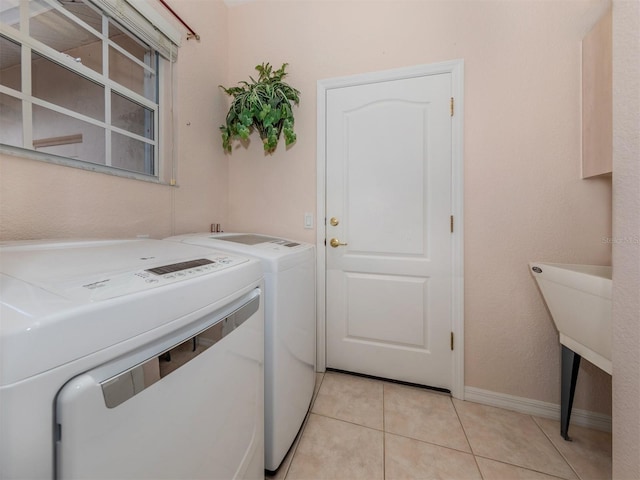 washroom featuring light tile patterned floors and washer and dryer