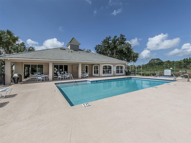 view of pool featuring a grill and a patio