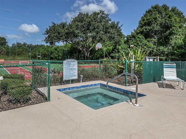 view of swimming pool featuring a community hot tub