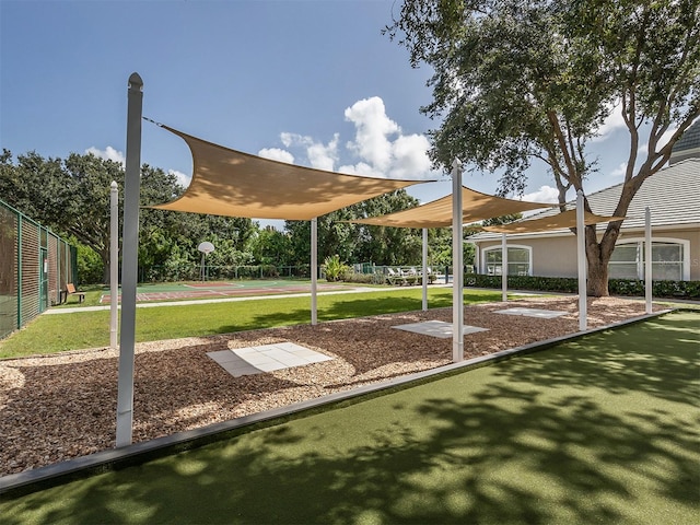 view of home's community featuring basketball court