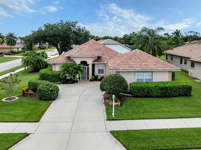 mediterranean / spanish-style home featuring a front yard