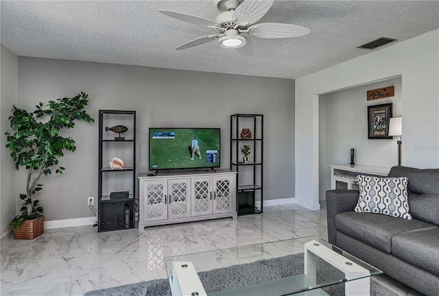 living room with a textured ceiling and ceiling fan