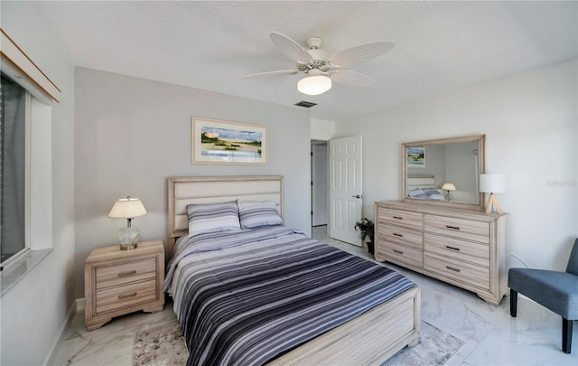 bedroom featuring a textured ceiling and ceiling fan