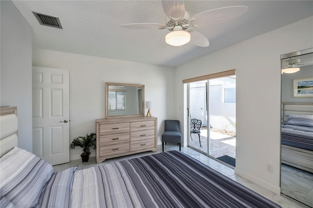 bedroom featuring a textured ceiling, access to outside, and ceiling fan