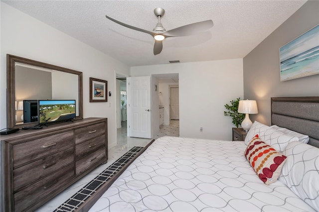 bedroom featuring a textured ceiling and ceiling fan