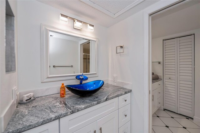 bathroom featuring vanity and a textured ceiling