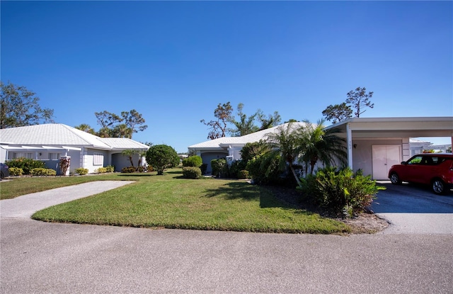 ranch-style house featuring a carport and a front lawn