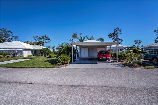 view of front of property with a front lawn and a carport