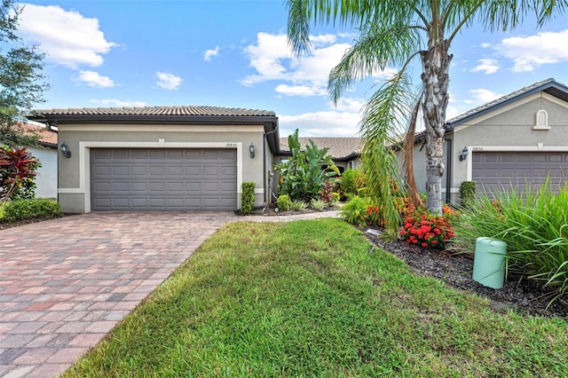 view of front facade featuring a front yard and a garage