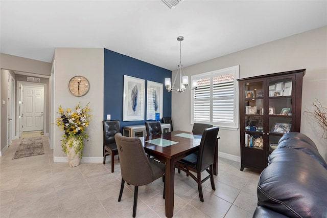 dining room featuring light tile patterned flooring and an inviting chandelier