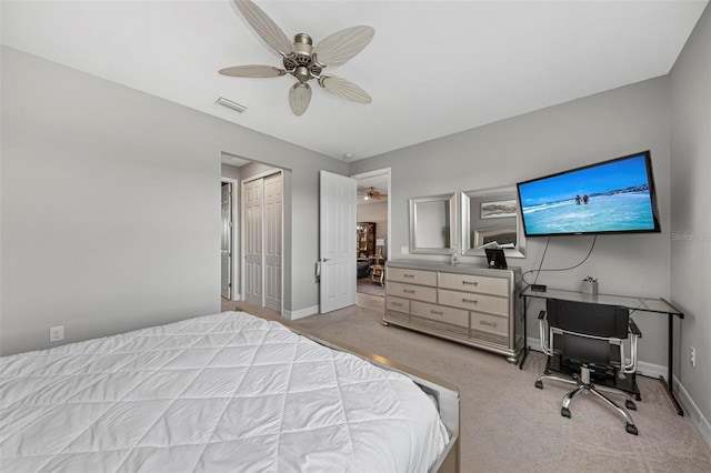 carpeted bedroom featuring ceiling fan and a closet