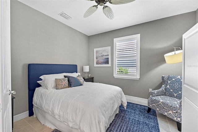 tiled bedroom featuring ceiling fan