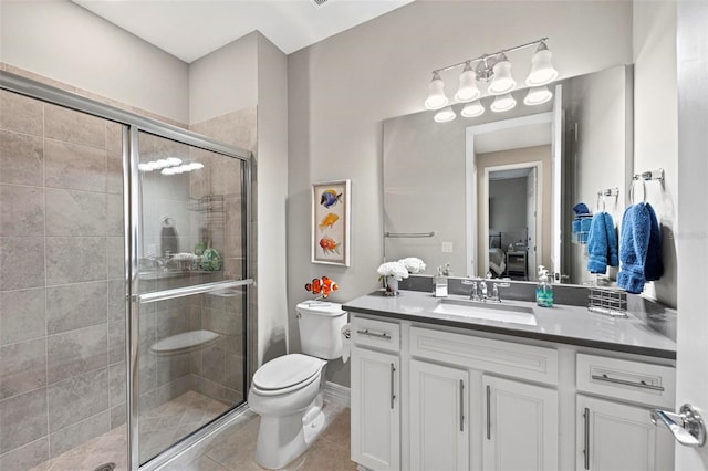 bathroom featuring tile patterned flooring, vanity, toilet, and an enclosed shower