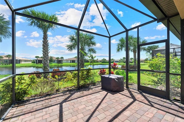 unfurnished sunroom featuring a water view