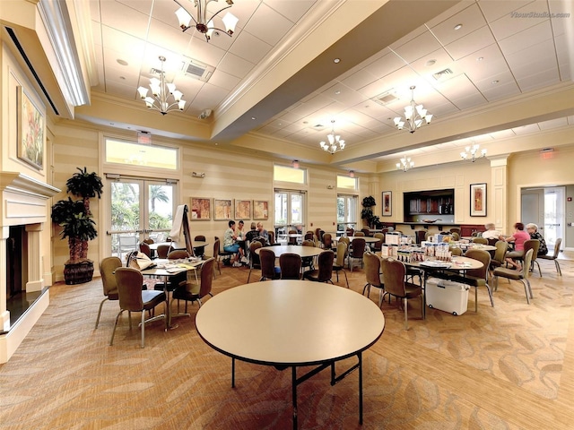 dining room featuring light colored carpet, ornamental molding, and a tray ceiling