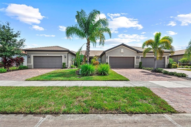 ranch-style home with a front yard and a garage