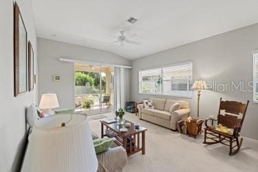 carpeted living room with vaulted ceiling and ceiling fan