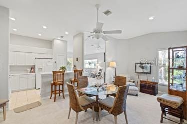 carpeted dining space featuring lofted ceiling and ceiling fan