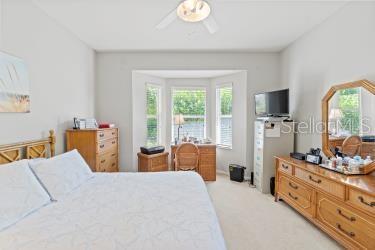 carpeted bedroom featuring ceiling fan