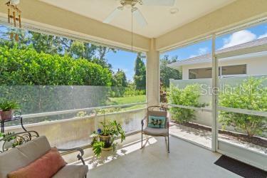 unfurnished sunroom with ceiling fan