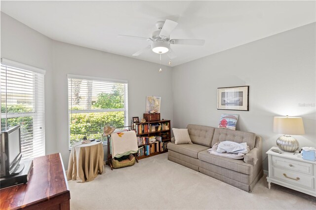 carpeted living room featuring ceiling fan