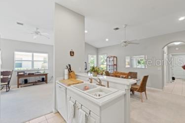 kitchen featuring a wealth of natural light, kitchen peninsula, and ceiling fan