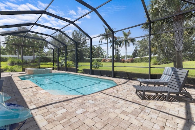 view of swimming pool with a pool with connected hot tub, a lanai, a patio, and a lawn