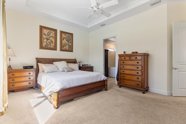 bedroom featuring baseboards, a raised ceiling, visible vents, and light colored carpet