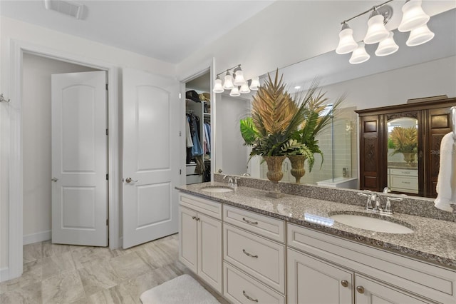 full bathroom with double vanity, a sink, visible vents, and a shower with door