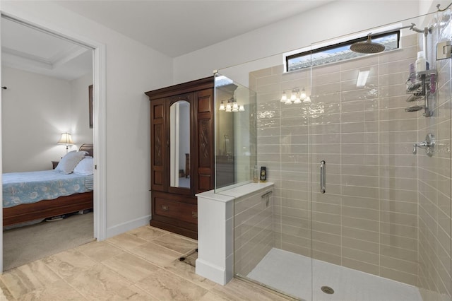 ensuite bathroom with a stall shower, baseboards, and ensuite bathroom