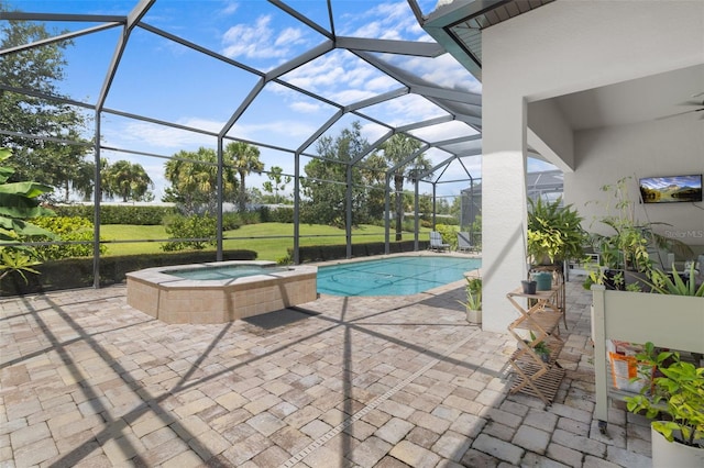 view of swimming pool with a lanai, a pool with connected hot tub, and a patio