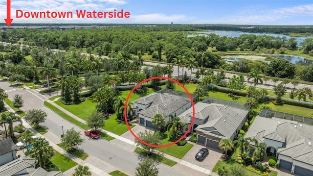 bird's eye view with a water view, a forest view, and a residential view