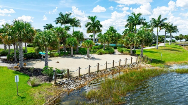 view of community featuring a water view and a lawn