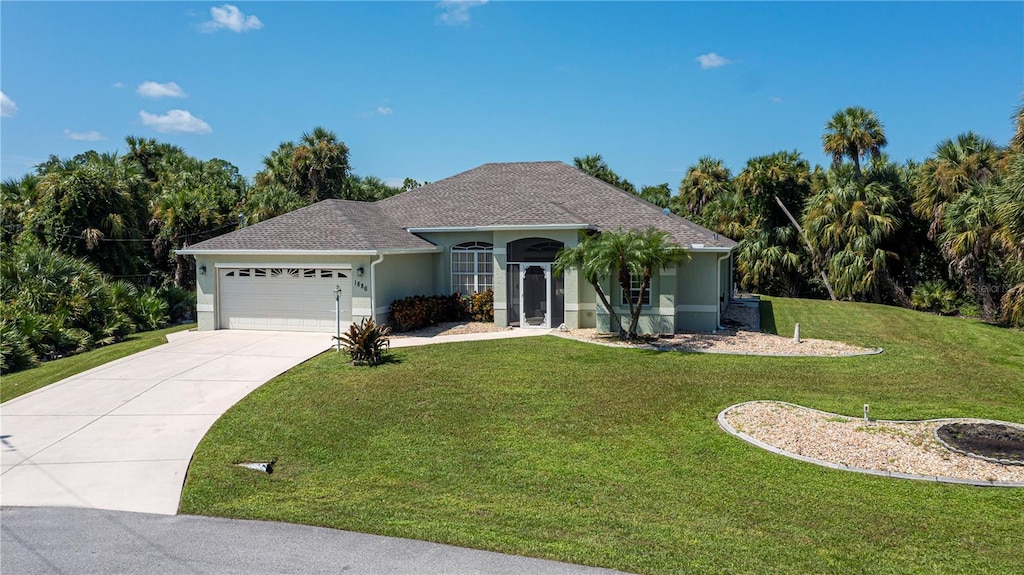 view of front of house featuring a front yard and a garage